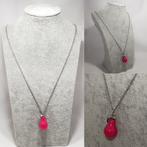 Women's pink pear drop pendant on silver tone link chain.