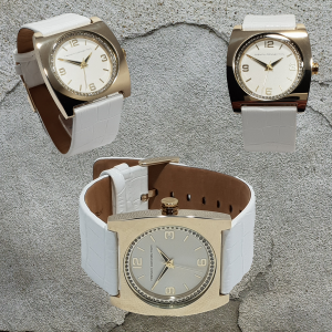 Finished with a polished gold-tone case, the white dial features matching gold-tone hands, numbers, and markers. The dial is also surrounded by diamante stones as pictured. To complete the great look and style of this lovely timepiece, it's fitted with a genuine French Connection leather strap band finished in a white, croc style with a gold-tone buckle. Supplied with original French Connection Box, as received by us, together with 2-year manufacturers warranty booklet. Dimensions: Case size: 40mm x 40mm Case Depth: 8mm Strap Width: 26mm Strap Length: 24.3mm